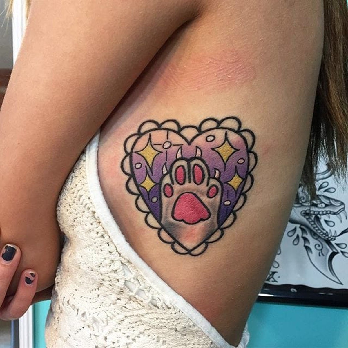 Tatouage patte de chien coloré.
